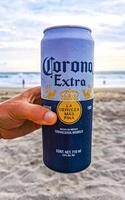 Puerto Escondido Oaxaca Mexico 2022 Corona Extra beer can on the beach at sunset Mexico. photo