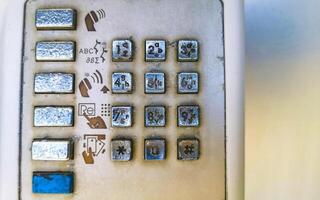 Old telephone box with handset and keypad Puerto Escondido Mexico. photo