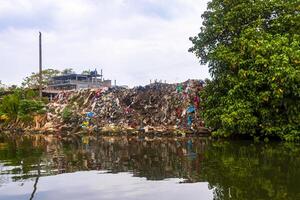 Terrible pile of garbage mangrove jungle Bentota Ganga Bentota Beach Sri Lanka. photo