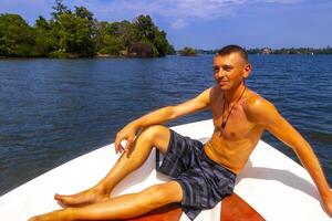 Boat safari mangrove jungle man male tourist River Bentota Beach Sri Lanka. photo