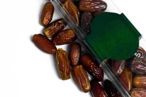 Dates fruit in plastick package with blank green label for product mockup design, dates product isolated white background photo