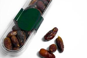 Dates fruit in plastick package with blank green label for product mockup design, dates product isolated white background photo