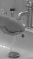 Hands wash procedure, cleaning hands with soap from viruses and contamination. Wash hands before dinner black and white monochrome footage background video