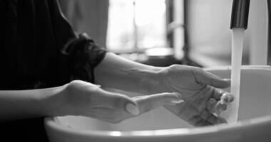 Hands wash procedure, cleaning hands with soap from viruses and contamination. Wash hands before dinner black and white monochrome footage background video