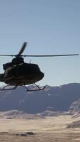 A helicopter flying over a mountain range in the desert video