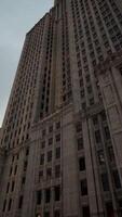 A towering skyscraper against a clear blue sky in New York City video