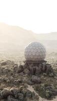 A massive dome-shaped observatory antenna in the middle of a vast desert video