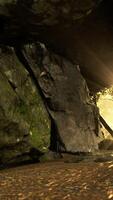 Shaft of light beaming down into large cave video