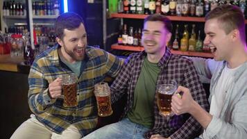 Group of happy friends having fun together, drinking beer in a bar, celebrating, happily smiling - friendship, togetherness concept video