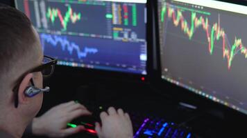 Crypto trader investor analyst broker using pc computer analyzing digital cryptocurrency exchange stock market trading graphs report thinking of investing funds risks doing global analysis video