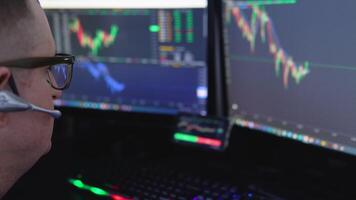 Crypto trader investor analyst broker using pc computer analyzing digital cryptocurrency exchange stock market trading graphs report thinking of investing funds risks doing global analysis video