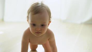 Smiling crawling cute baby in diaper at home on floor video