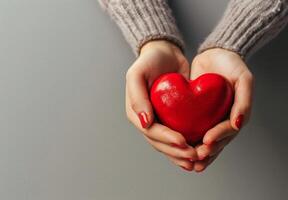 Person Holding Red Heart in Hands photo