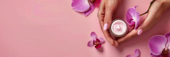 Womans Hands Holding Jar of Cream by Pink Flowers photo