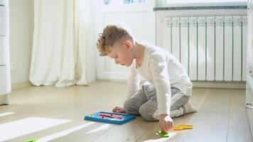 Little boy playing education toy on the floor in nursery video