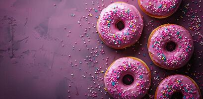 Pink Sprinkled Donuts on a Purple Background photo