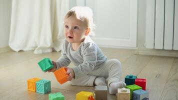 Child playing with colorful toy blocks. Kids play. Educational game for baby and toddler video