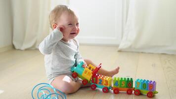 Child playing with toy colorful train video