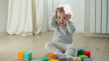 Child playing with colorful toy blocks. Kids play. Educational game for baby and toddler video