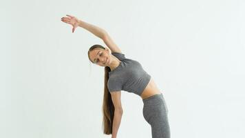 Beautiful girl in yoga studio. A woman doing a yoga. Lady in a top video