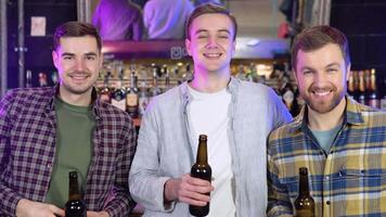 Smiling carefree friends enjoying drinking together in bar video