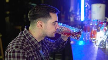 Portrait of a handsome caucasian young man drinking tasty golden refreshing beer beverage in a pub video