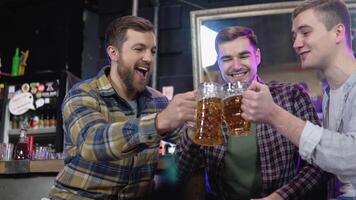 groupe de content Jeune Hommes en buvant du froid Brouillon bière, bavardage et ayant bien temps à pub. souriant insouciant copains profiter en buvant ensemble dans bar video