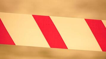 Red white warning tape barrier ribbon swinging in the wind across exotic sea beach background without people. No entry Red White caution tape. No holiday concept, delayed travel, no summer plans video