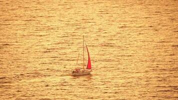 Yacht on calm sunset sea. Luxury cruise trip. Side view of white boat on deep blue water. Aerial view of rich yacht sailing sea. Summer journey on luxury ship. Slow motion video