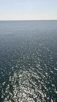 Sea water surface. Low angle view from kayak, camera flies over clear sea water. Nobody. Holiday recreation concept. Abstract nautical summer ocean nature. Slow motion. Close up. Vertical video