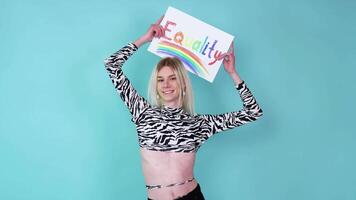 Young gay man holding paper with equality message. Equality concept video