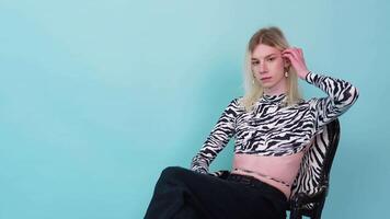 Youth gay man sits on color background. Gender expression pride and equality concept video