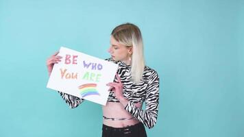 Attractive blond gay caucasian man holding a protest sign during a LGBT pride parade. Be who you are video