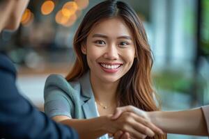 Two Business People Shaking Hands in an Office photo