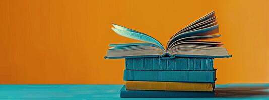 Stack of Books on Orange Background photo