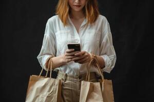 Asian Woman Holding Shopping Bags and Looking at Her Phone photo