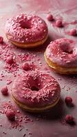 Three Pink Sprinkled Donuts on Pink Surface photo