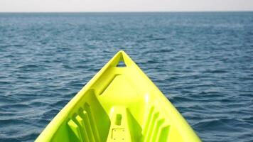 Sea water surface. Low angle view from kayak, camera flies over the clear green sea water. Nobody. Holiday recreation concept. Abstract nautical summer ocean nature. Slow motion. Close up. video