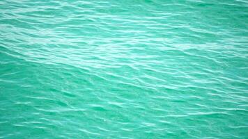 Sea water surface. Camera flies over the calm azure sea. Nobody. Holiday recreation concept. Abstract nautical summer ocean nature. Weather and climate change. Slow motion. Close up video