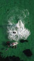 A man flies on a FlyBoard. Aerial top down view. Water extreme sport, azure summer sea with outdoors active people enjoying water sports. Flyboarding and seariding, Recreation and sports concepts. video