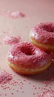 Three Pink Sprinkled Donuts on Pink Surface photo