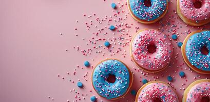 Pink and Blue Sprinkled Donuts on a Pink Background photo