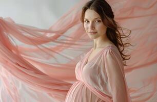 Pregnant Woman Posing on Pink Background photo