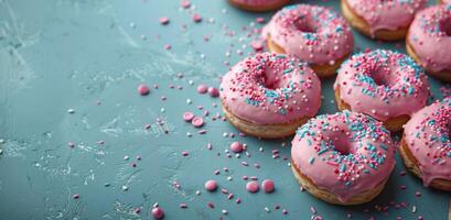 Pink and Blue Sprinkled Donuts on a Pink Background photo