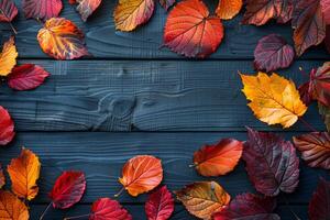 Blackboard With Autumn Leaves on Wooden Background photo