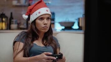 Close up of woman losing at games on tv console with controller. Irritated person playing games with joystick on christmas eve to celebrate winter holiday with technology. video