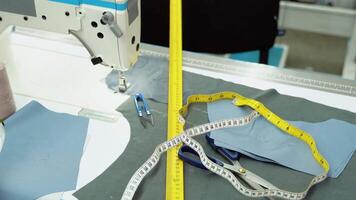 Threads, pattern, scissors, tape measure, and a sewing machine. Workplace of seamstress video