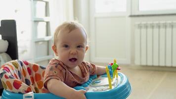 First steps of the girl in a baby walker video