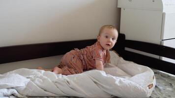 Crawling funny baby girl at home in bed video
