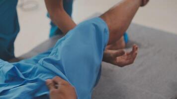 Patient at the physiotherapy doing physical exercises with his therapist video